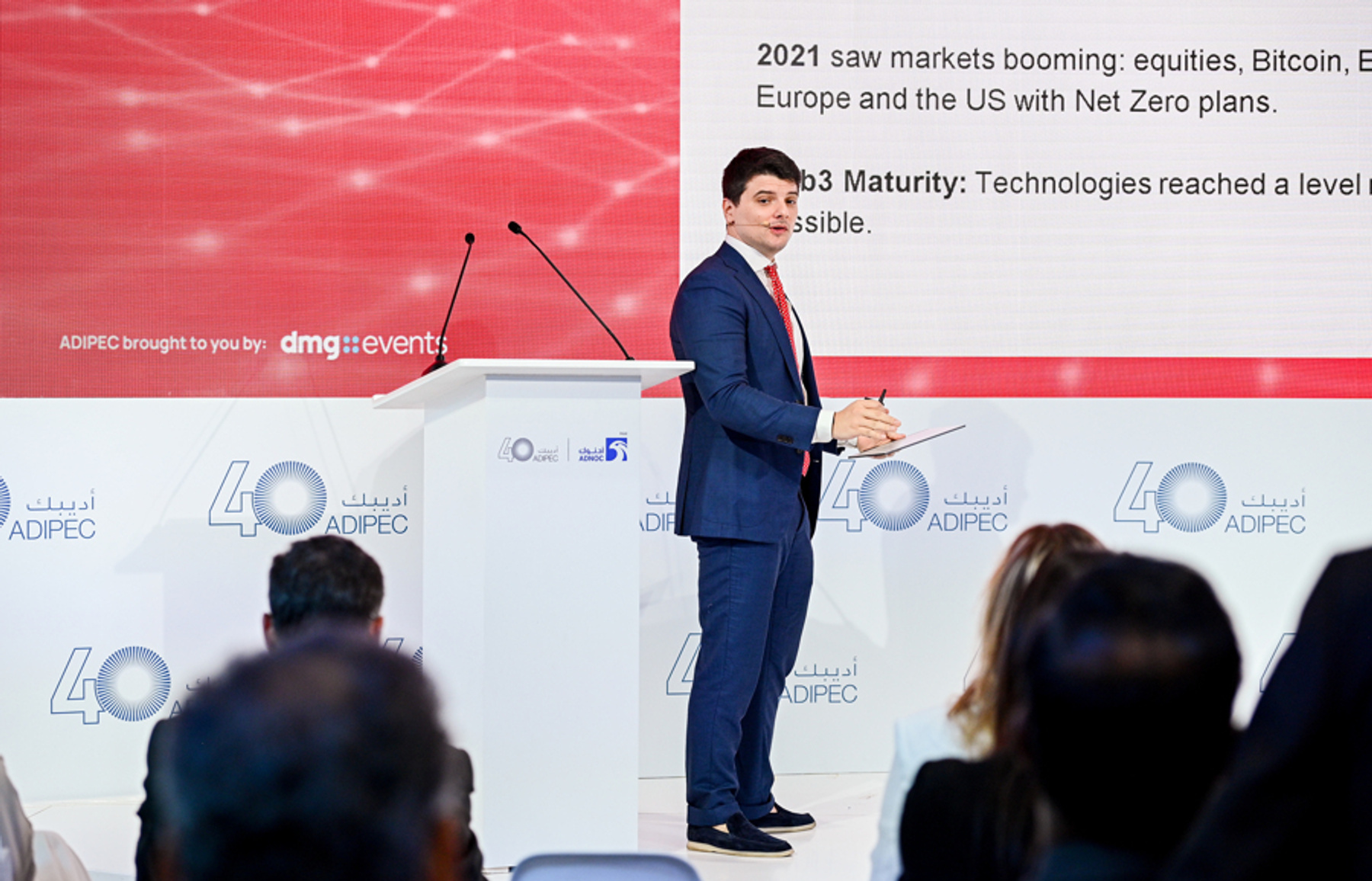 Giorgio Alessandro Donà-Danioni at the ADIPEC 2024 podium presenting on blockchain in the voluntary carbon market