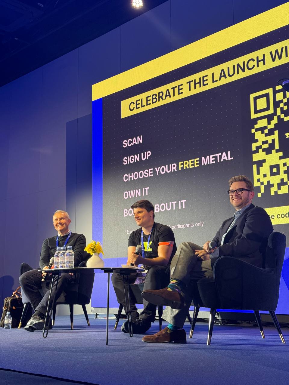 Giorgio Alessandro Donà-Danioni at the TezDev 2026 fireside chat on tokenized commodities trading, smiling while holding a microphone